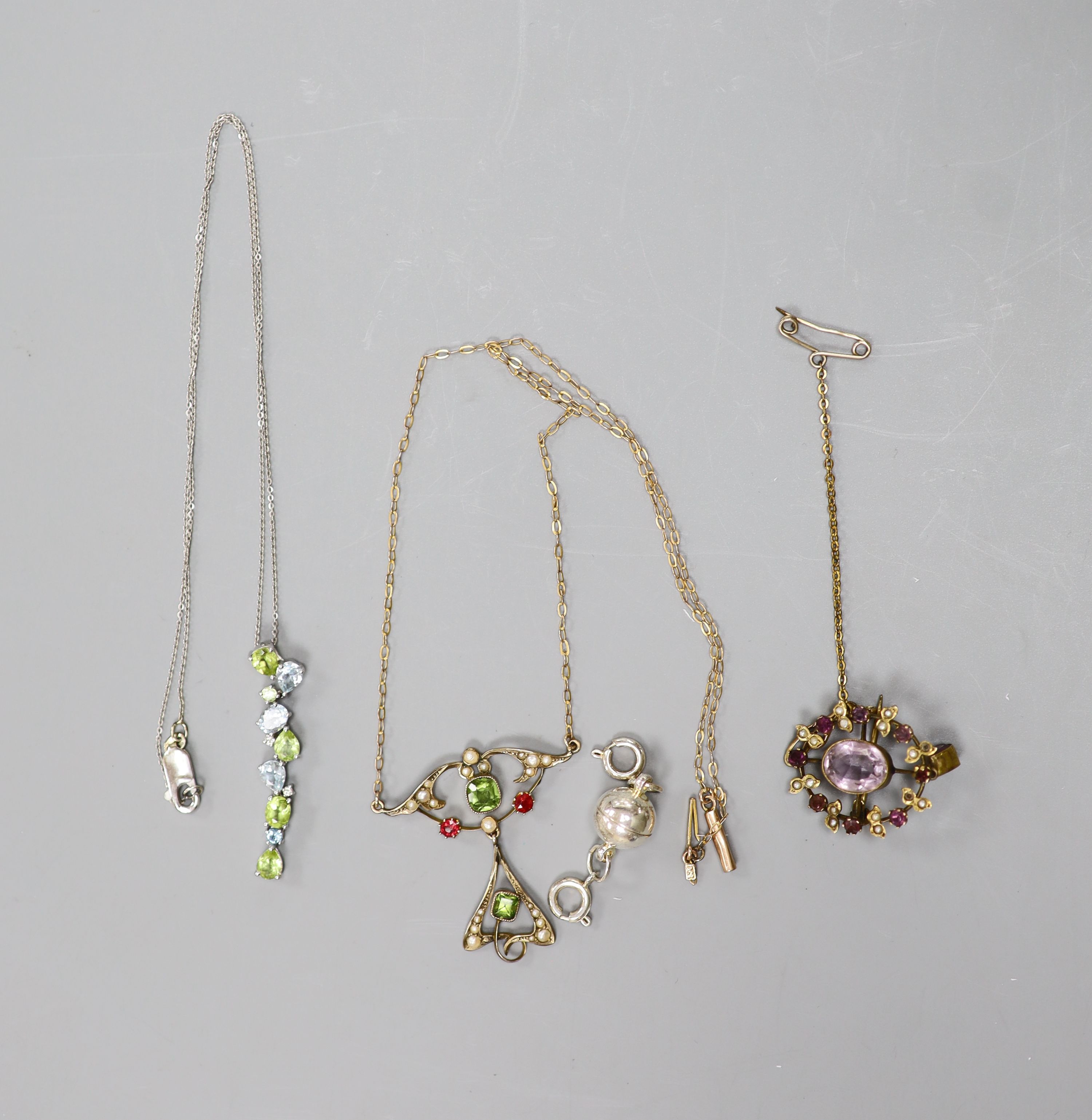 An Art Nouveau style 9ct yellow gold, peridot, pearl and ruby openwork pendant on chain and two other items